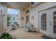 Relaxing screened porch with wicker furniture and ceiling fan at 6062 Armada St, Tavares, FL 32778