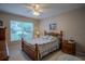 Bedroom with wood furniture and a ceiling fan at 6062 Armada St, Tavares, FL 32778