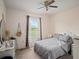 Spacious bedroom with a gray comforter and large window at 18744 Sabal St, Orlando, FL 32833
