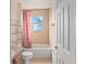 Clean bathroom with a tub, shower, and coral shower curtain at 18744 Sabal St, Orlando, FL 32833