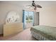 Bedroom with floral bedspread and light-colored dresser at 18744 Sabal St, Orlando, FL 32833