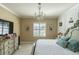 Comfortable bedroom with a large bed, dresser, and pool view at 615 Del Pilar Dr, Groveland, FL 34736