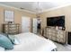 Spacious bedroom with a large bed, dresser, and flat-screen TV at 615 Del Pilar Dr, Groveland, FL 34736