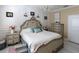 Elegant Primary bedroom with a large bed, dresser, and chandelier at 615 Del Pilar Dr, Groveland, FL 34736