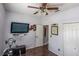 Bedroom with TV, exercise bike, and ample closet space at 615 Del Pilar Dr, Groveland, FL 34736