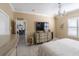 Bright bedroom with a large bed, dresser, and view into dining area at 615 Del Pilar Dr, Groveland, FL 34736