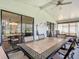 Sunroom with tiled table, chairs, and sliding glass doors at 645 Rainbow Blvd, The Villages, FL 32159