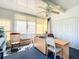Versatile sunroom featuring a workspace and ample storage at 645 Rainbow Blvd, The Villages, FL 32159