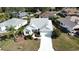Charming one-story home with driveway, front yard landscaping, and mature trees at 17755 Se 85Th Ellerbe Ave, The Villages, FL 32162