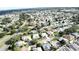 An aerial view of a residential area featuring various homes surrounded by trees and driveways at 17755 Se 85Th Ellerbe Ave, The Villages, FL 32162