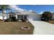 Charming single-story home with a landscaped front yard and attached two-car garage at 17755 Se 85Th Ellerbe Ave, The Villages, FL 32162