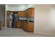 Kitchen features oak cabinets, stainless steel appliances, and tile flooring at 17755 Se 85Th Ellerbe Ave, The Villages, FL 32162