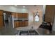 Kitchen with double stainless steel sink and oak cabinets, open to dining area at 17755 Se 85Th Ellerbe Ave, The Villages, FL 32162