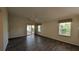 Bright living room with wood-look flooring, ceiling fan, and sliding glass doors to the patio at 17755 Se 85Th Ellerbe Ave, The Villages, FL 32162