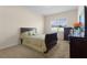 Bright bedroom with carpeted floor, a queen-size bed, and a window with blinds at 309 Misty Haven Dr, Groveland, FL 34736