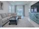Spacious living room with a large sectional sofa, coffee table, and access to a patio at 5035 Stokes Way, Wildwood, FL 34785
