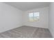 Simple bedroom with grey carpet and a window at 3046 Ruby Falls Dr, Deland, FL 32724