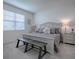Primary bedroom featuring a king-size bed and an ensuite bathroom at 5035 Stokes Way, Wildwood, FL 34785