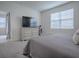 Primary bedroom with a king-size bed, dresser and en-suite bathroom at 5035 Stokes Way, Wildwood, FL 34785