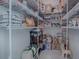 Walk-in pantry with ample shelving for storage at 5035 Stokes Way, Wildwood, FL 34785