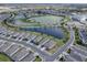 Aerial view of a community with houses,ponds, and green spaces at 5035 Stokes Way, Wildwood, FL 34785
