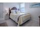 Charming bedroom with a queen-size bed and a window with blinds at 5035 Stokes Way, Wildwood, FL 34785