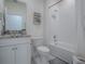 Clean bathroom with a shower/tub combo and granite countertop at 5035 Stokes Way, Wildwood, FL 34785
