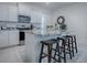Kitchen island with granite countertops and breakfast bar seating at 5035 Stokes Way, Wildwood, FL 34785