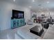 Open living room featuring a large TV, comfy seating, and view into the kitchen at 5035 Stokes Way, Wildwood, FL 34785