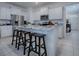 Kitchen island with seating and granite countertops at 5035 Stokes Way, Wildwood, FL 34785