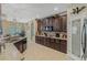 Large kitchen with an island, dark wood cabinets, and granite countertops at 349 Morning View Dr, Winter Garden, FL 34787