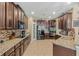 Spacious kitchen with dark wood cabinets, granite countertops, and stainless steel appliances at 349 Morning View Dr, Winter Garden, FL 34787
