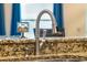 Close-up of a modern kitchen faucet and granite countertop at 349 Morning View Dr, Winter Garden, FL 34787