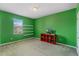 Green-walled bedroom with media console and window at 349 Morning View Dr, Winter Garden, FL 34787