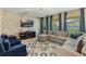 Living area featuring sectional sofa and stone wall at 349 Morning View Dr, Winter Garden, FL 34787