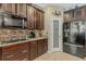 Modern kitchen with dark wood cabinets, granite counters and walk-in pantry at 349 Morning View Dr, Winter Garden, FL 34787