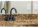 Bathroom vanity with granite countertop and dark bronze faucet at 349 Morning View Dr, Winter Garden, FL 34787