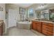 Elegant bathroom with double vanity, soaking tub, and ample counter space at 349 Morning View Dr, Winter Garden, FL 34787