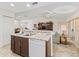 Kitchen island with double sink and dishwasher, open to living room at 32857 Timberwood Dr, Leesburg, FL 34748