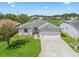 Single-story house with a large front yard and driveway, aerial view at 32857 Timberwood Dr, Leesburg, FL 34748