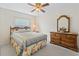 Guest bedroom with dresser and ceiling fan at 32857 Timberwood Dr, Leesburg, FL 34748