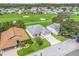 Aerial view of home with golf course in background at 32857 Timberwood Dr, Leesburg, FL 34748