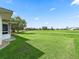 Landscaped backyard with golf course view at 32857 Timberwood Dr, Leesburg, FL 34748