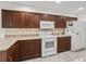 Well-equipped kitchen featuring dark wood cabinets and granite countertops at 32857 Timberwood Dr, Leesburg, FL 34748