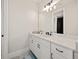 Modern bathroom with white cabinets and quartz countertop at 16820 Bolsena Dr, Bella Collina, FL 34756