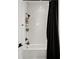 Bathroom with white herringbone tile and black shower curtain at 16820 Bolsena Dr, Bella Collina, FL 34756