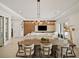 Bright dining room with large wooden table and modern light fixture at 16820 Bolsena Dr, Bella Collina, FL 34756