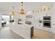 Luxury kitchen with white cabinetry, large island, and water views at 16820 Bolsena Dr, Bella Collina, FL 34756