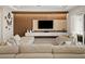 Modern living room with wood-paneled accent wall and comfortable seating at 16820 Bolsena Dr, Bella Collina, FL 34756