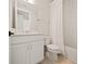 Clean bathroom with a white vanity, shower/tub combo, and neutral tile at 16820 Bolsena Dr, Bella Collina, FL 34756